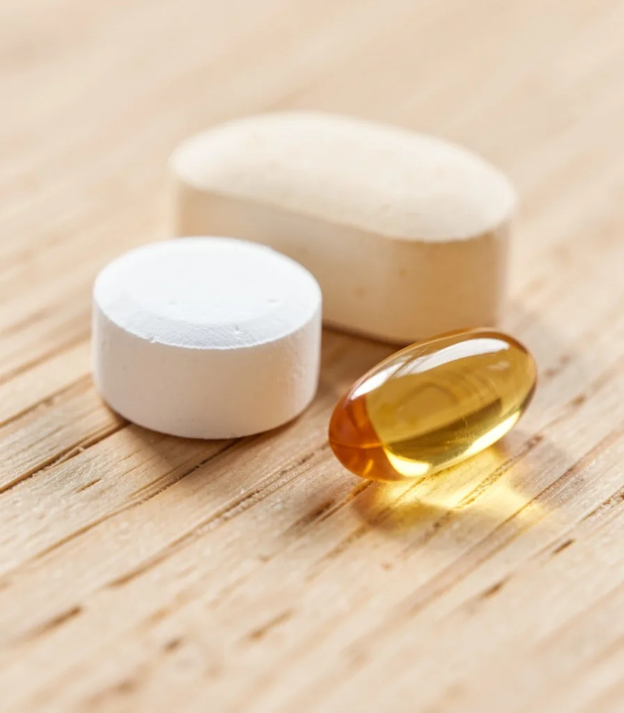 Natural supplement capsules on a warm surface